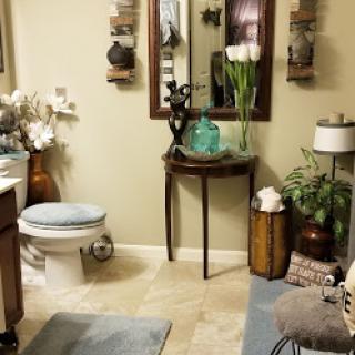 A beautifully styled bathroom featuring elegant decor and plant accents.