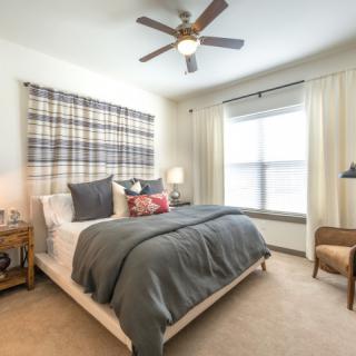 A modern bedroom with a plaid headboard and cozy decor.