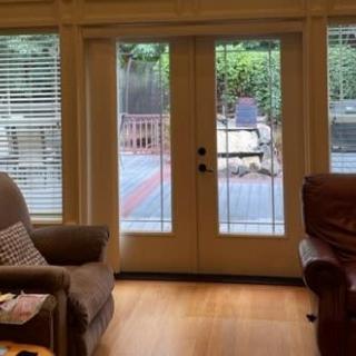 A cozy living room with French doors leading to a backyard patio.