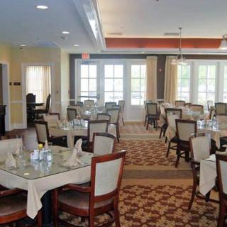 An elegant and empty restaurant dining room set with tables and chairs.