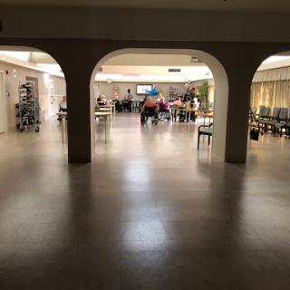 A spacious hospital waiting area with a modern design and soft lighting.