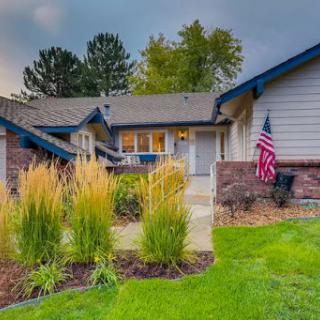 A charming house with well-maintained landscaping and an American flag proudly displayed.