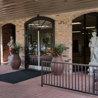 A welcoming entrance featuring decorative statues and planters.