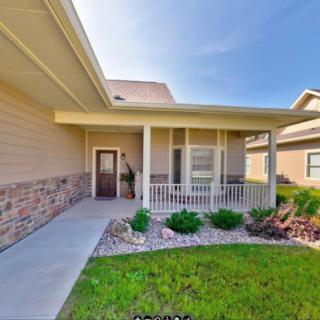 A suburban house with a welcoming front porch and well-maintained landscaping.