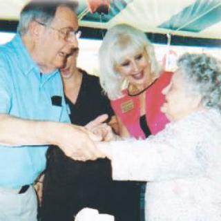 A group of people interacting and celebrating indoors.