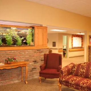 A cozy living room with comfortable seating and a built-in aquarium.