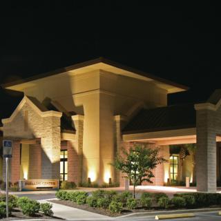A well-lit building entrance at night showcasing modern architectural design.