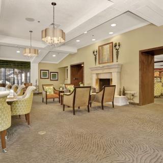 A cozy dining room with elegant seating and a warm fireplace.