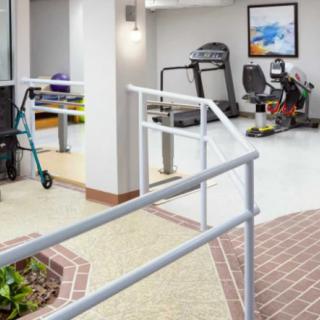 A rehabilitation center featuring exercise equipment for physical therapy.
