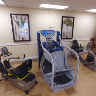 A variety of fitness and rehabilitation equipment in a gym setting.