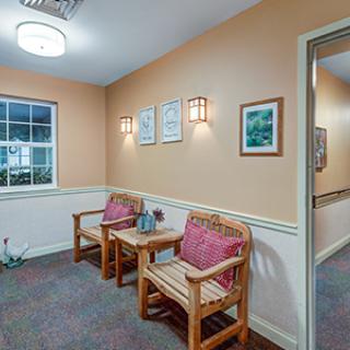 A cozy waiting area with seating and wall decor.