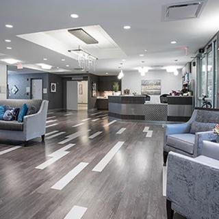 A modern lobby area with comfortable seating and a reception desk.