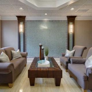 A contemporary living room with comfortable seating and elegant decor.