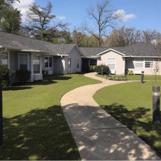 A suburban neighborhood with small houses and a winding pathway.
