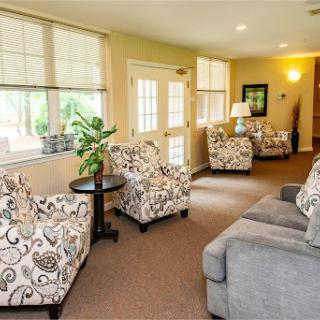 A cozy living room featuring comfortable seating and natural light.