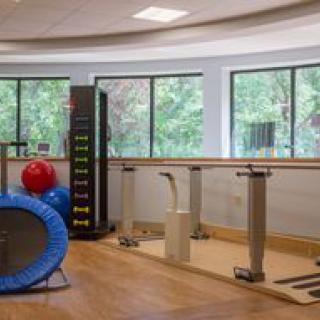 A rehabilitation room equipped with various exercise and therapy equipment.