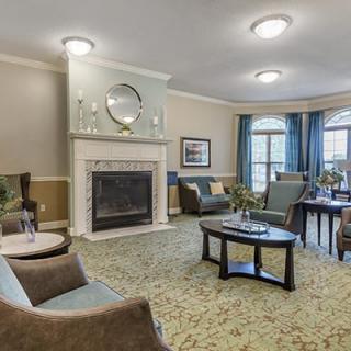 A cozy living room with a fireplace and comfortable seating arrangement.