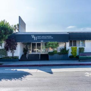 Exterior view of a medical clinic building with signage.