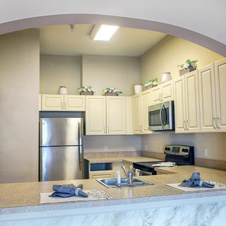 A modern kitchen with stainless steel appliances and a spacious countertop.