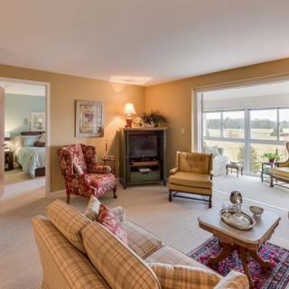 A cozy living room with comfortable seating and large windows offering a view.