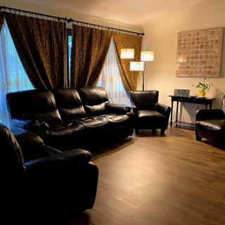 A cozy living room with leather seating and warm lighting.