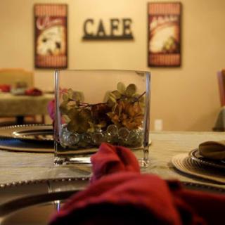 A cozy cafe dining setup with elegant decor and a touch of floral arrangement.