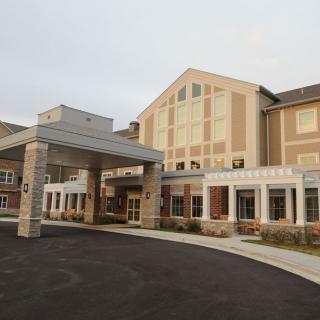 A large building with a prominent entrance and multiple windows.