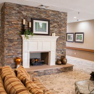 Cozy living room with a stone fireplace and elegant decor.