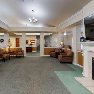 A spacious lobby with comfortable seating, a fireplace, and elegant lighting.