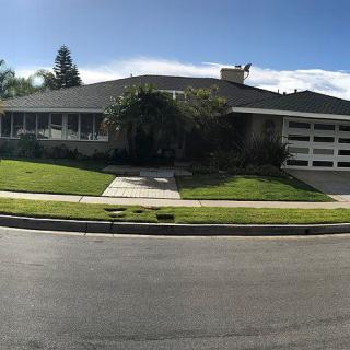 A suburban house with a well-maintained front yard and a two-car garage.