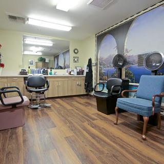 Interior view of a hair salon with chairs and mirrors.