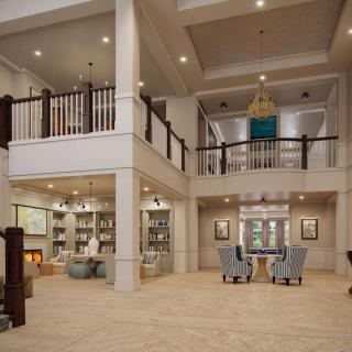 Spacious modern living room with high ceilings and stylish decor.
