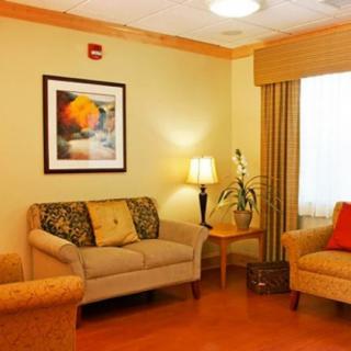 A cozy living room with comfortable sofas and warm lighting.