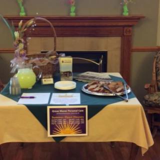 A table set up for an event, featuring lemonade, cookies, and informational flyers.