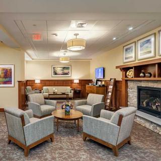 A cozy lounge area featuring a fireplace and comfortable seating arrangements.