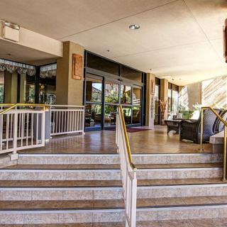Entrance with stairs and outdoor seating at a building.