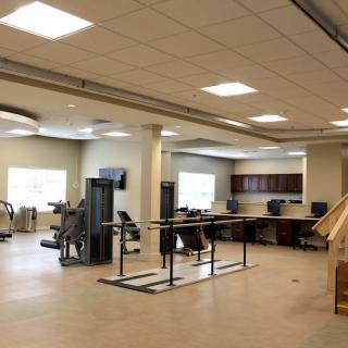 A modern gym interior with various exercise equipment and workout spaces.