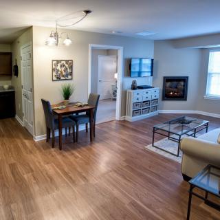 Modern open-concept living and dining area with hardwood floors and stylish furnishings.