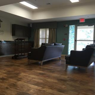 A cozy lounge area featuring modern sofas and ample natural light.