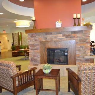 A cozy lounge area with a fireplace and comfortable seating.