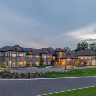 A modern residential house with illuminated windows at twilight.