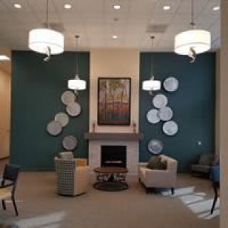 A modern lobby with elegant seating and a fireplace centerpiece.
