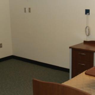 An empty office space featuring a desk and chair.