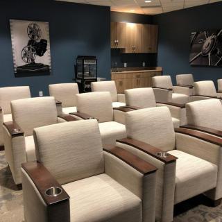 A modern home theater room with comfortable seating and stylish decor.