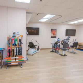 A well-equipped rehabilitation gym with exercise machines and therapy equipment.