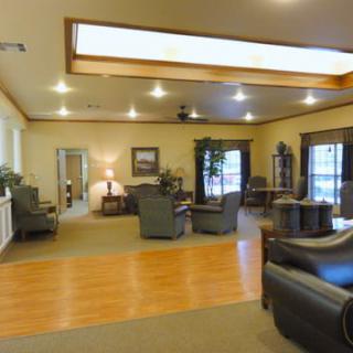 A spacious living room with comfortable seating and large windows.
