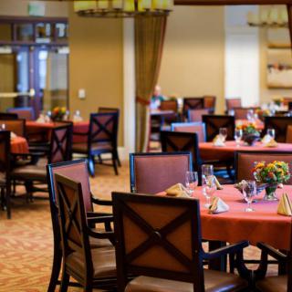 An elegant restaurant dining area with neatly arranged tables and chairs, ready for guests.