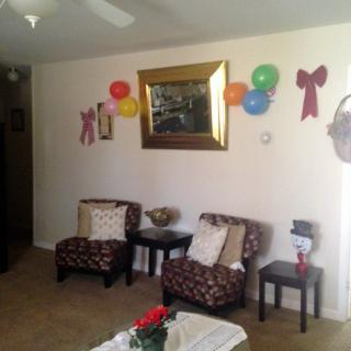 A cozy living room decorated with colorful balloons and a large mirror on the wall.
