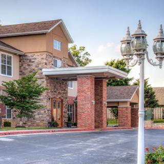 A hotel building with a welcoming entrance and well-maintained surroundings.