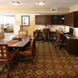 Spacious office interior with desks, chairs, and a patterned carpet.